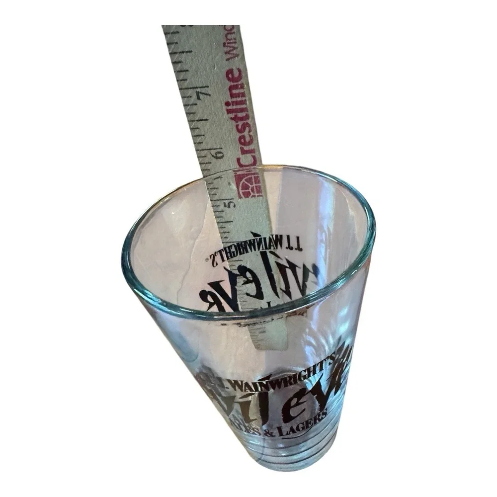 JJ Wainwrights Evil Eye Ales & Lagers Beer Pint Glass Vintage Black Logo Barware